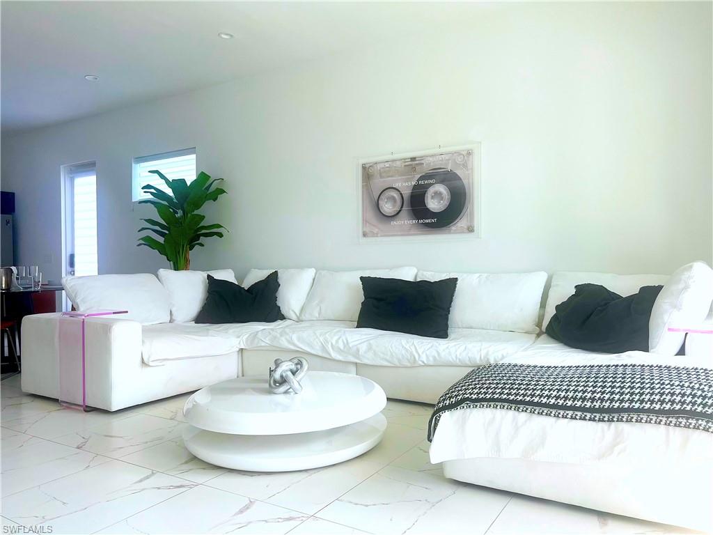 4064 Full Moon Court Naples, FL 34112 - Photo 24 of 50 a bedroom with a bed and a couch