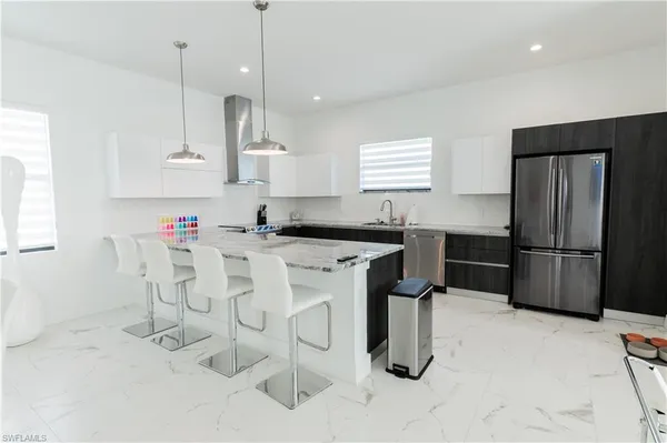 a living room with lots of furniture and kitchen view