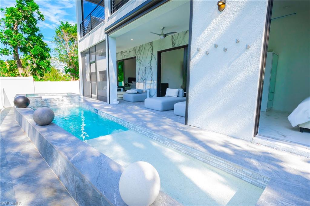 4064 Full Moon Court Naples, FL 34112 - Photo 3 of 50 a view of a hallway with a dining table and chair