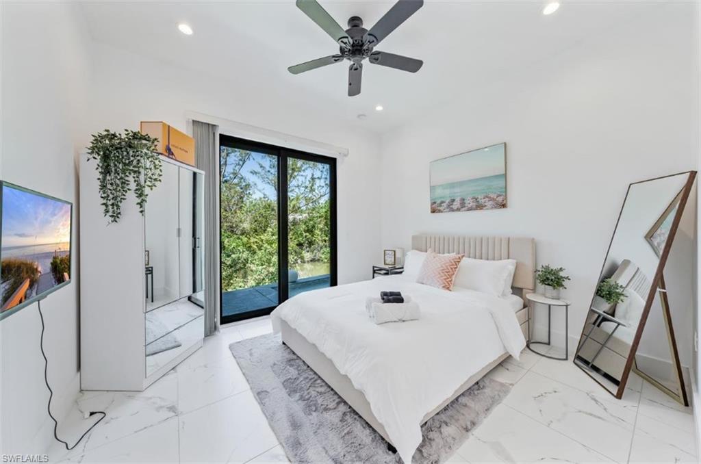 4064 Full Moon Court Naples, FL 34112 - Photo 31 of 50 a living room with furniture and a large window