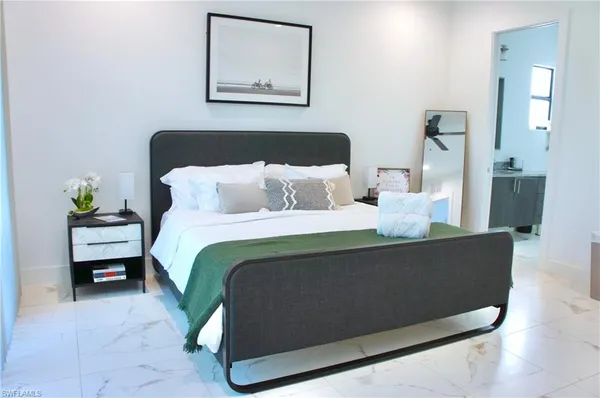 a bedroom with bed and wooden floor