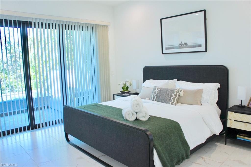 4064 Full Moon Court Naples, FL 34112 - Photo 34 of 50 a bedroom with bed and wooden floor