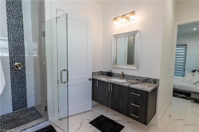 a bathroom with a granite countertop sink a toilet and a mirror