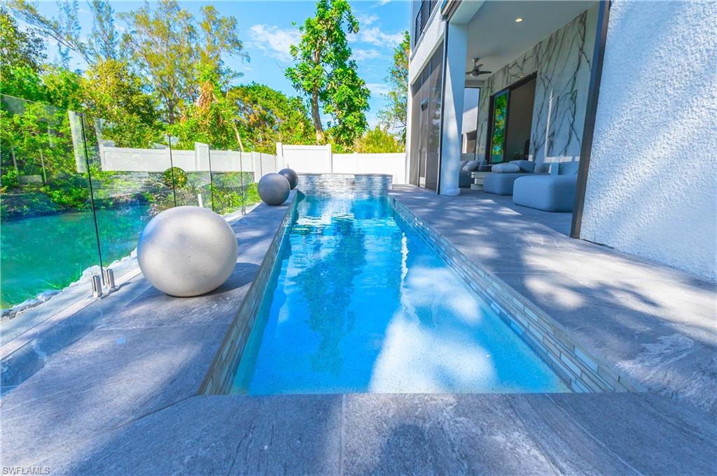 4064 Full Moon Court Naples, FL 34112 - Photo 4 of 50 a view of a chairs and table in the patio