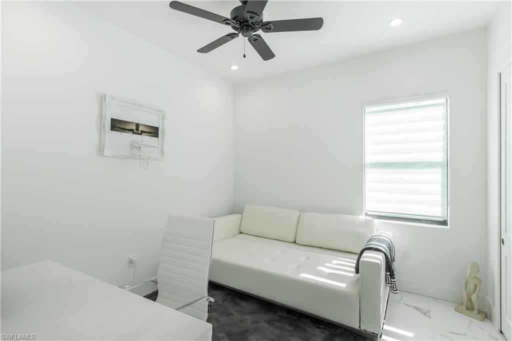 4064 Full Moon Court Naples, FL 34112 - Photo 46 of 50 a living room with a couch and a window