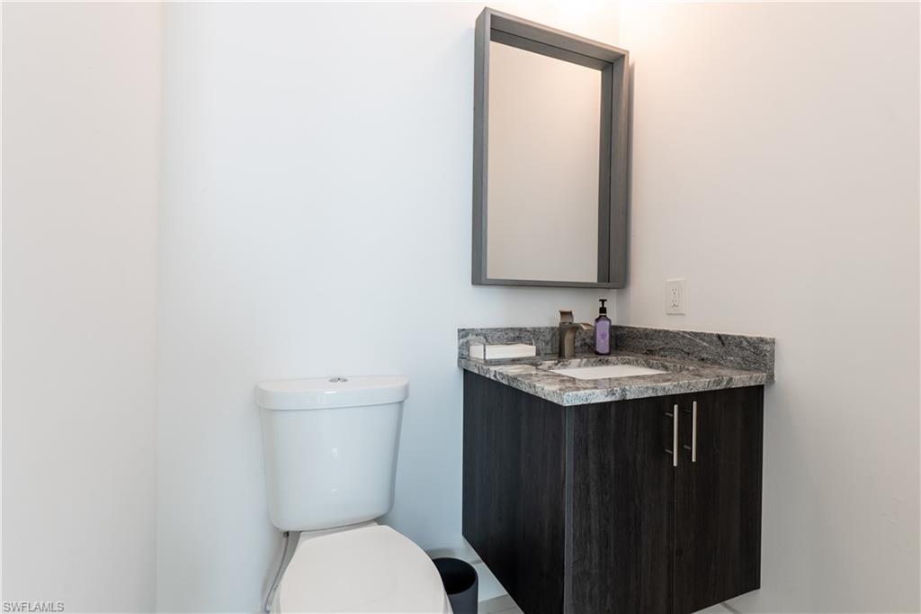 4064 Full Moon Court Naples, FL 34112 - Photo 47 of 50 a bathroom with a toilet sink and mirror