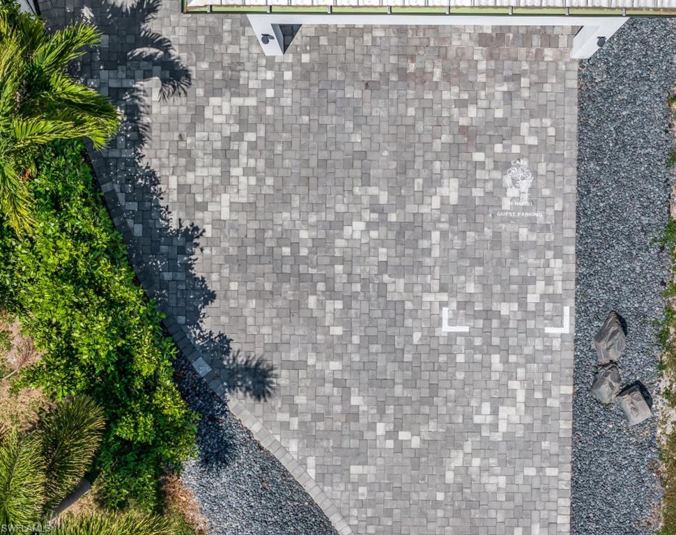 4064 Full Moon Court Naples, FL 34112 - Photo 49 of 50 a brick building with a yard