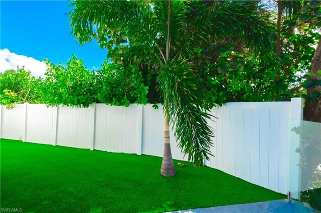 a white bench sitting in backside of a house