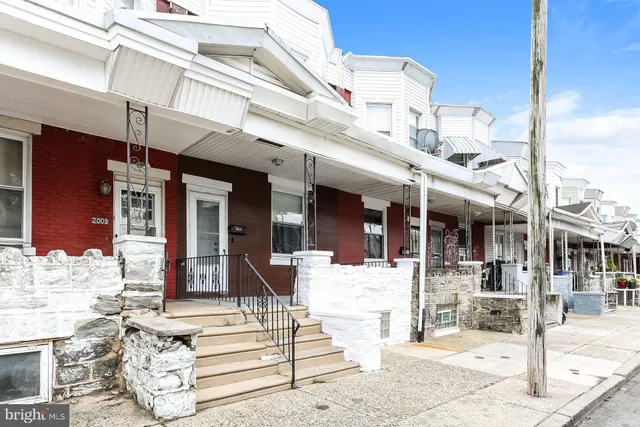 a view of a building with large windows and plants