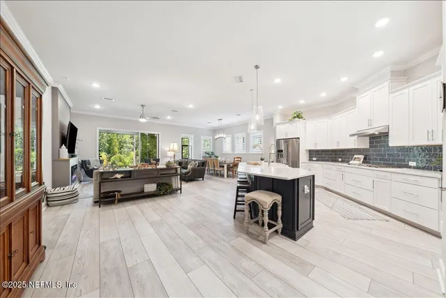 a kitchen with a sink appliances and cabinets