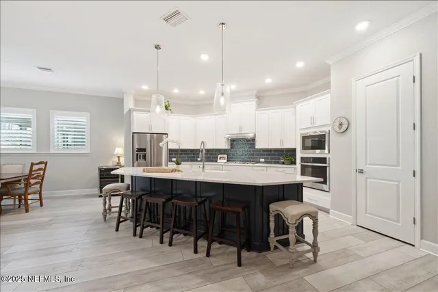 a large kitchen with a table and chairs