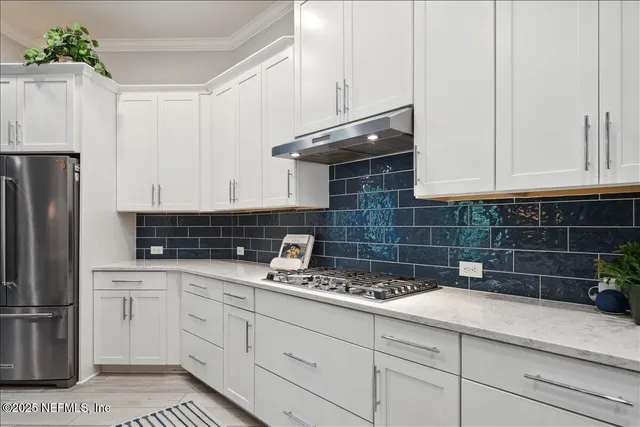 a kitchen with appliances a sink and cabinets