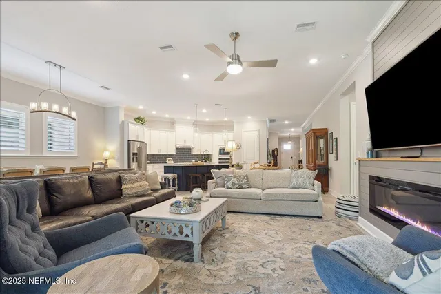 a living room with fireplace furniture and a flat screen tv