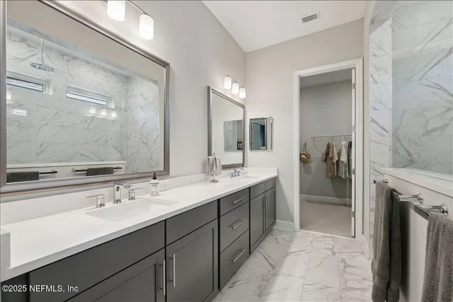 a spacious bathroom with a sink double vanity and a mirror
