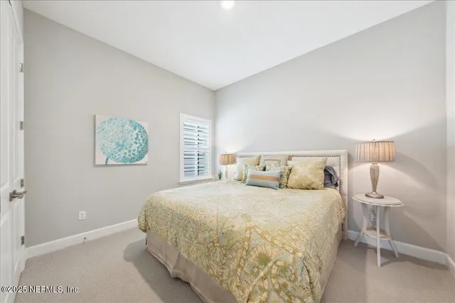 a bedroom with a bed and a lamp