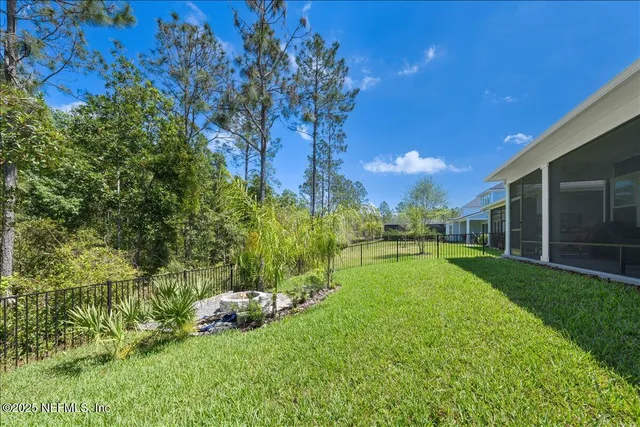 a view of a backyard with large trees
