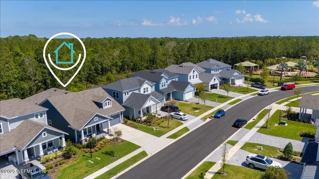 an aerial view of a house with a swimming pool outdoor seating and yard