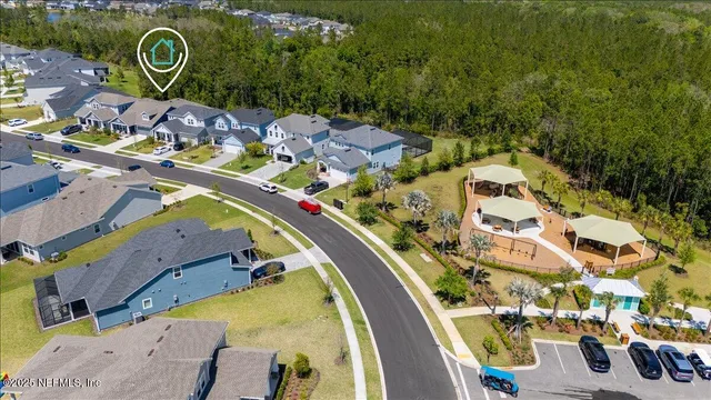 an aerial view of a swimming pool with outdoor seating and yard