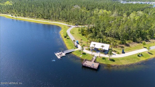 an aerial view of a house with a swimming pool patio and outdoor seating
