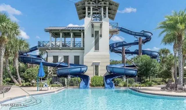 a backyard of a house with table and chairs