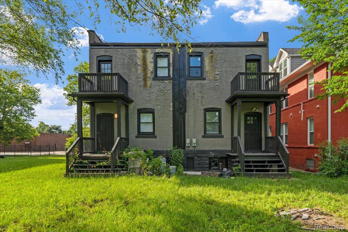 58 East Philadelphia Street Detroit, MI 48202 - Photo 24 of 24 Two-story brick exterior featuring individual entryways with covered porches and second-story balconies