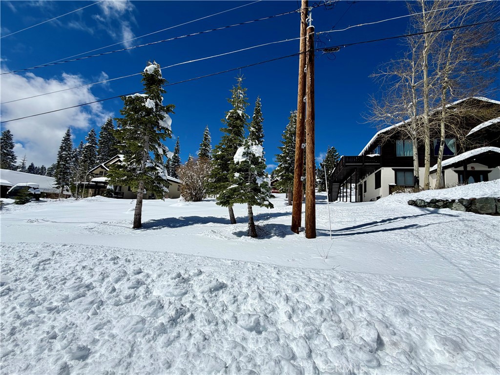 a view of a house with snow on the road