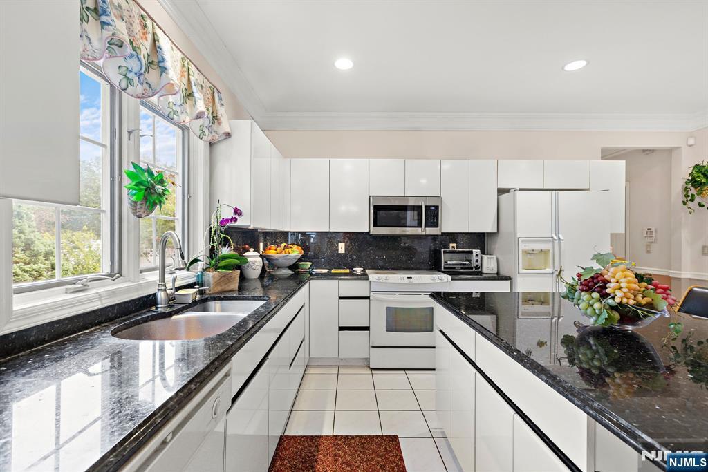 163 Rutherford Road Mahwah, NJ 07430 - Photo 15 of 33 a kitchen with stainless steel appliances granite countertop a sink a stove and cabinets