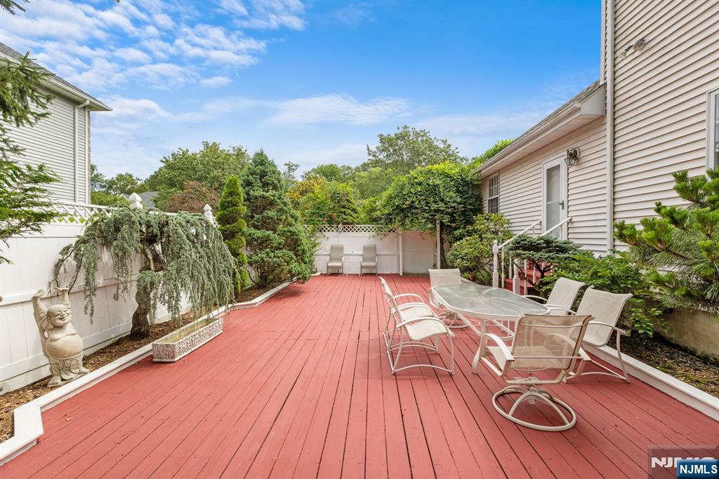 163 Rutherford Road Mahwah, NJ 07430 - Photo 32 of 33 a balcony with wooden floor table and chairs