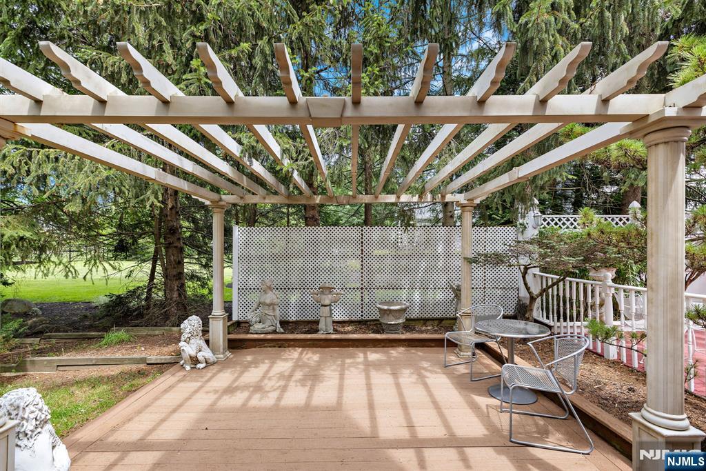 163 Rutherford Road Mahwah, NJ 07430 - Photo 33 of 33 a view of a patio with table and chairs with wooden floor and fence