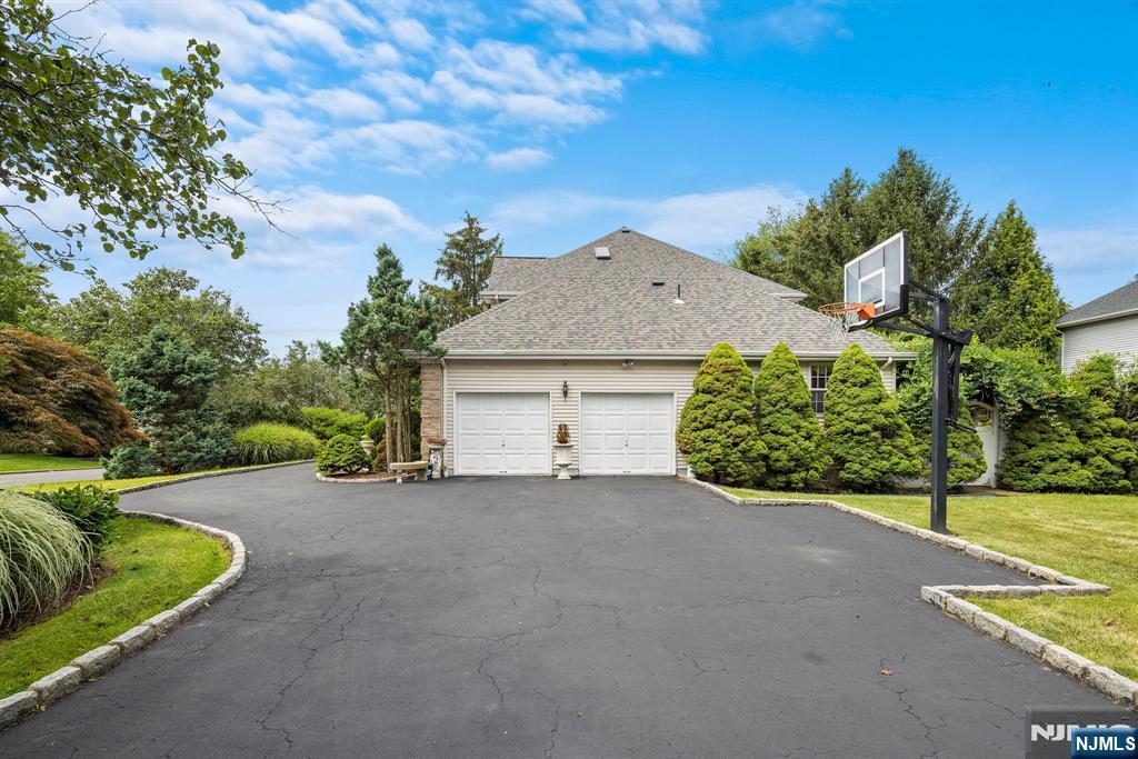 163 Rutherford Road Mahwah, NJ 07430 - Photo 4 of 33 a view of a house with a yard and garage