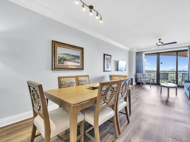a view of a dining room with furniture and a large window