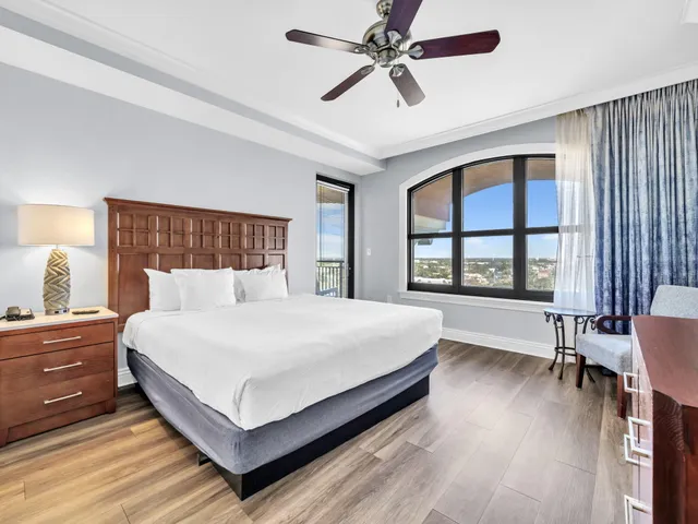 a bedroom with a large bed and a large window