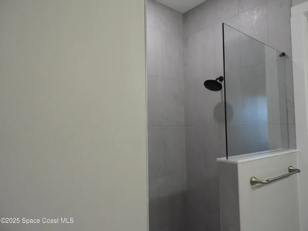 a spacious bathroom with double sink and mirror
