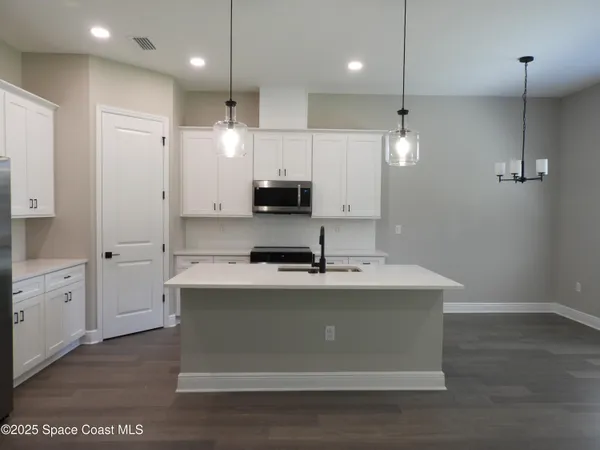 a bathroom with a sink a window and a mirror