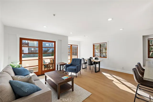a living room with furniture and floor to ceiling window