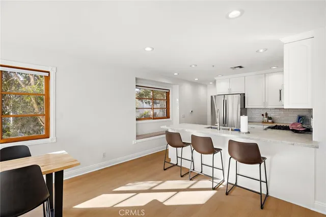 a dining room with furniture and a window