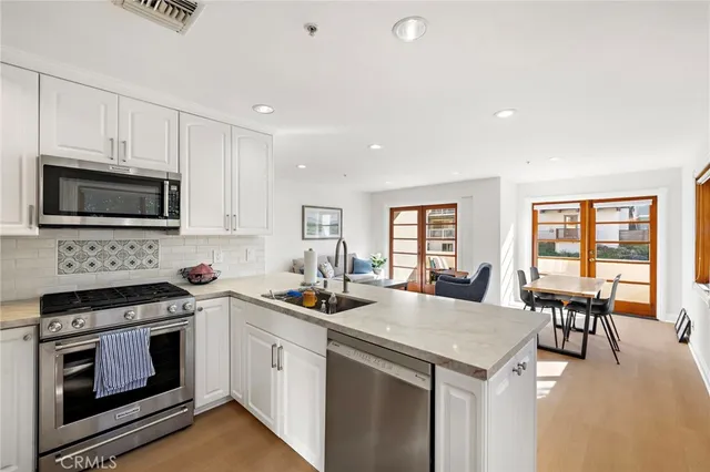 a kitchen with a stove a sink and a microwave
