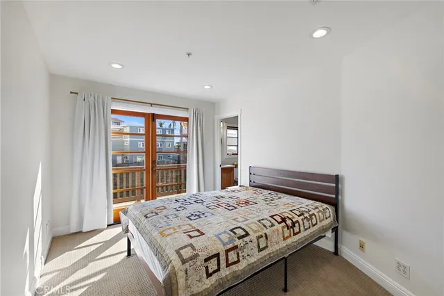 a bedroom with a large bed and a window