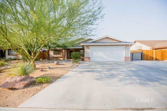 312 East Upjohn Avenue Ridgecrest, CA 93555 - Photo 1 of 35 a front view of a house with a yard and potted plants