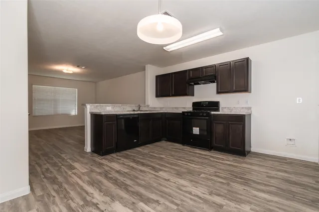 a kitchen with a refrigerator and a sink