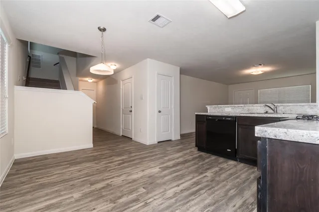 a kitchen with a sink a refrigerator and a stove