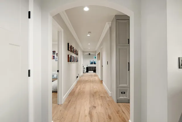 a spacious bedroom with a bed and a flat screen tv