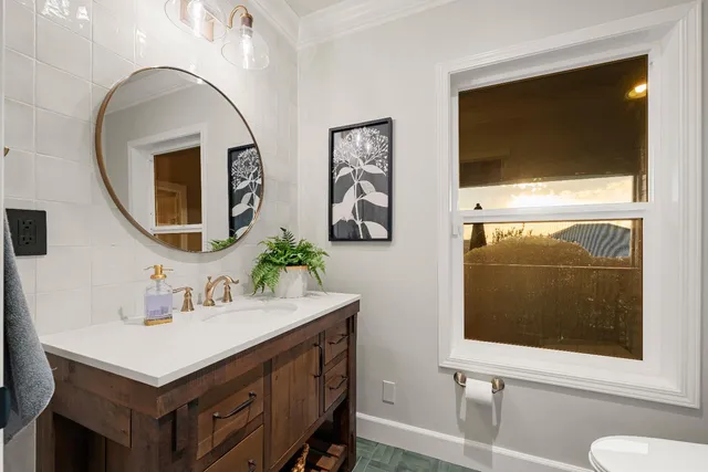 a living room with furniture flat screen tv and a large window