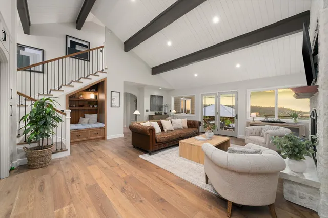 a view of living room with furniture and a floor to ceiling window