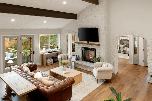 a kitchen with stainless steel appliances kitchen island granite countertop a table chairs sink and cabinets