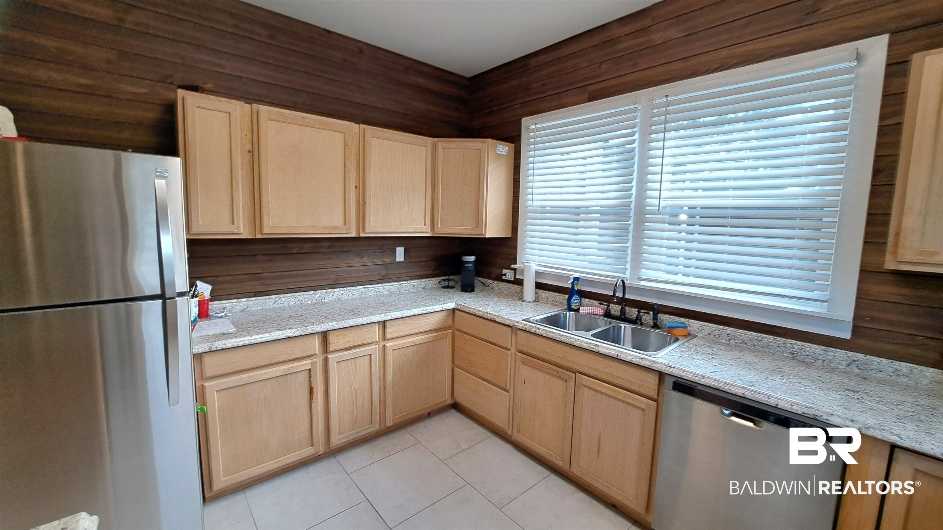 110 South Main Street Evergreen, AL 36401 - Photo 9 of 27 Kitchen featuring light-toned cabinetry, light-colored countertops, and stainless steel appliances