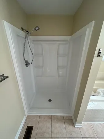 a bathroom with a glass shower door