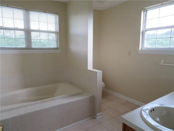 a white bath tub sitting next to a window