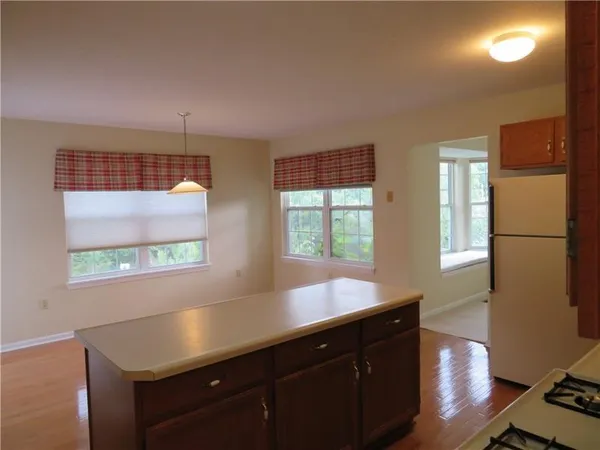 a kitchen with wooden cabinets and a window