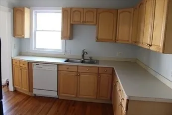 a kitchen with stainless steel appliances granite countertop a sink a stove and cabinets